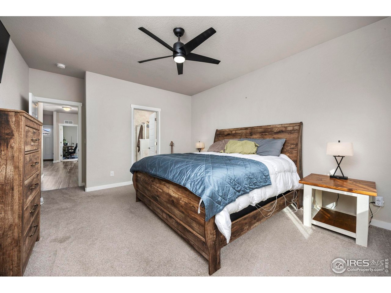 1344 87th Avenue Greeley, CO 80634 - Photo 12 of 31 a bedroom with a bed and a ceiling fan