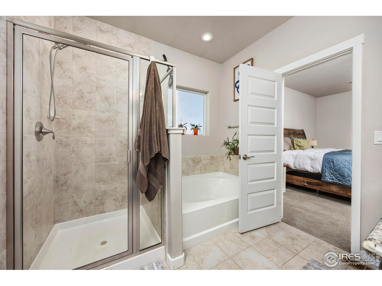 1344 87th Avenue Greeley, CO 80634 - Photo 14 of 31 a bathroom with a tub shower and sink