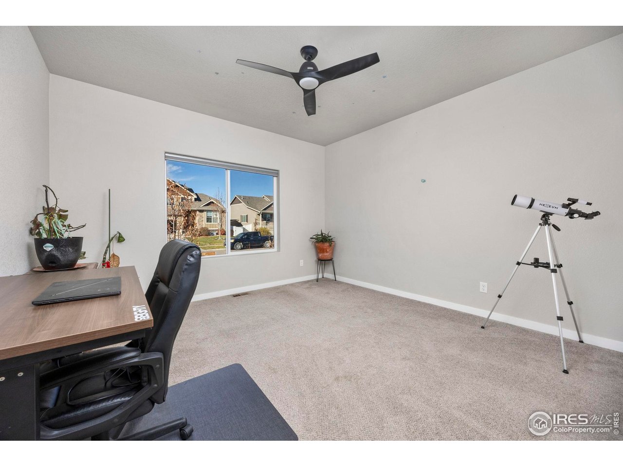 1344 87th Avenue Greeley, CO 80634 - Photo 15 of 31 a work room with furniture and a ceiling fan