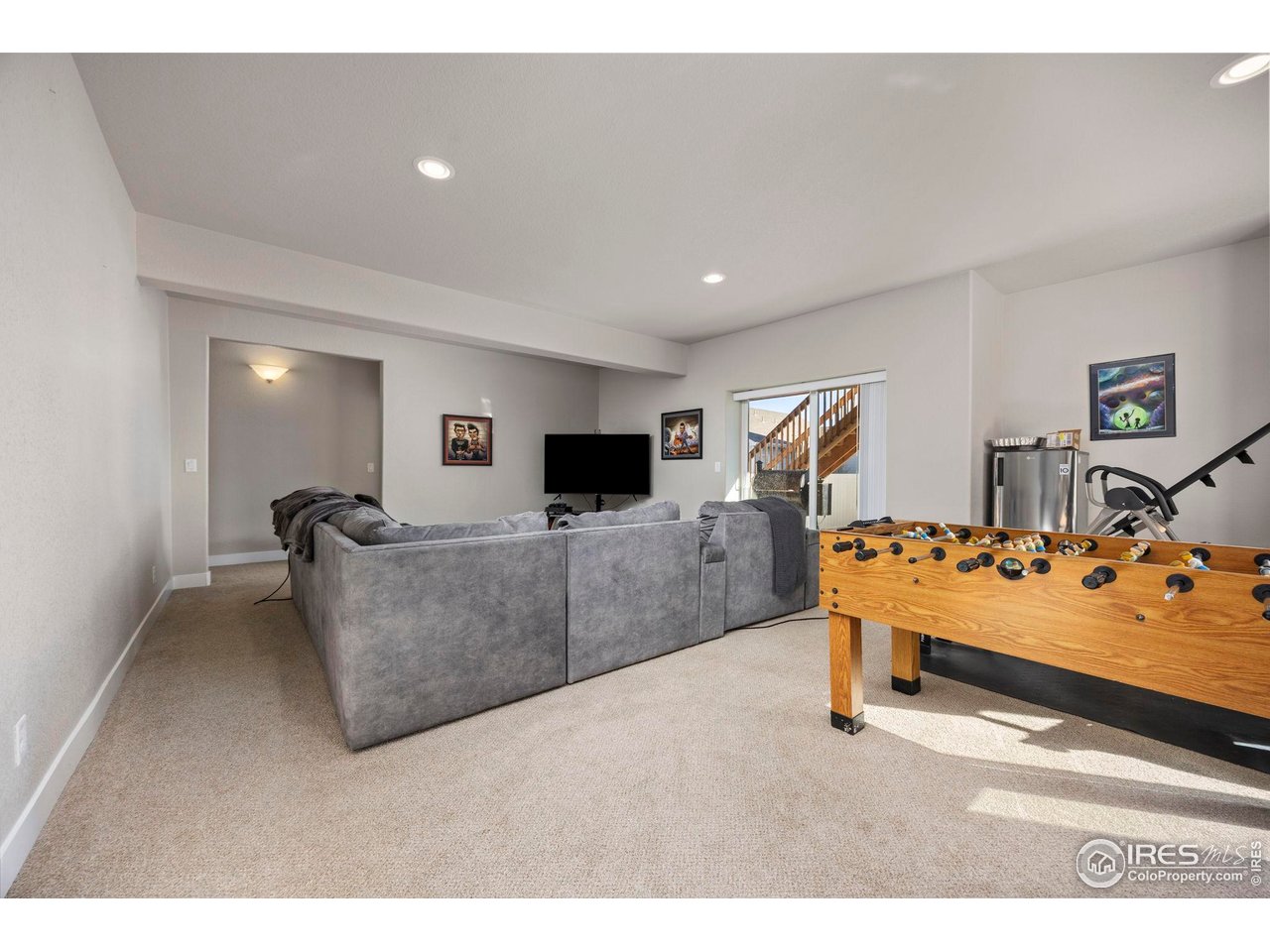 1344 87th Avenue Greeley, CO 80634 - Photo 18 of 31 a living room with furniture and a flat screen tv