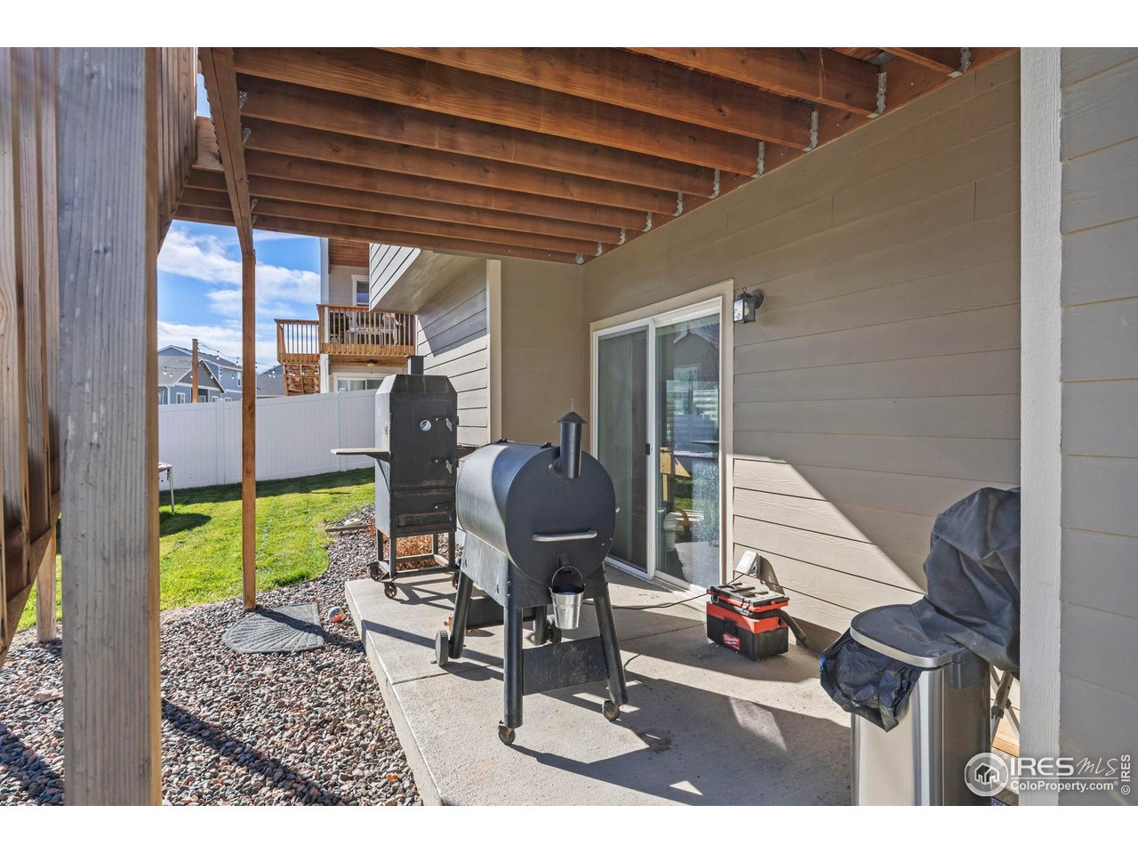 1344 87th Avenue Greeley, CO 80634 - Photo 31 of 31 a living room with furniture and a floor to ceiling window