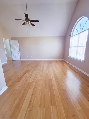 wooden floor in an empty room with a window