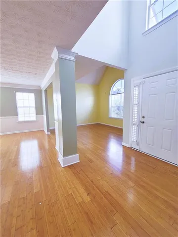 a view of empty room with wooden floor