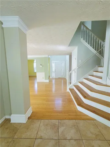 a view of entryway and hall with wooden floor