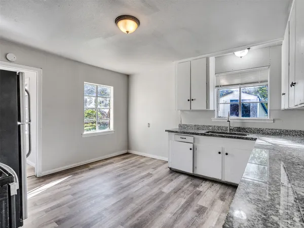 a bathroom with granite countertop a sink and a vanity