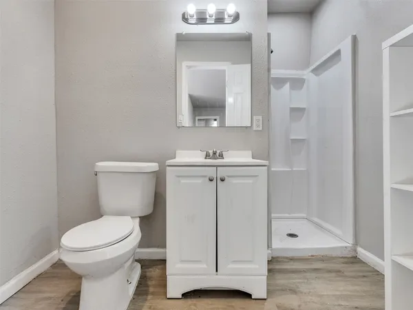 a bathroom with a toilet sink and shower