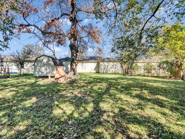 a view of a wooden house with a yard