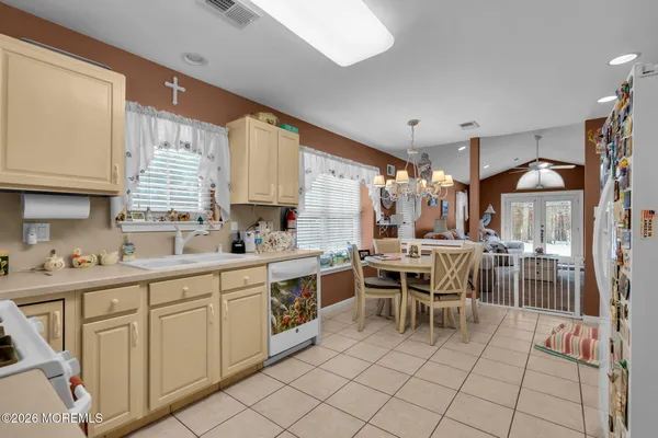 a kitchen with a sink and chairs