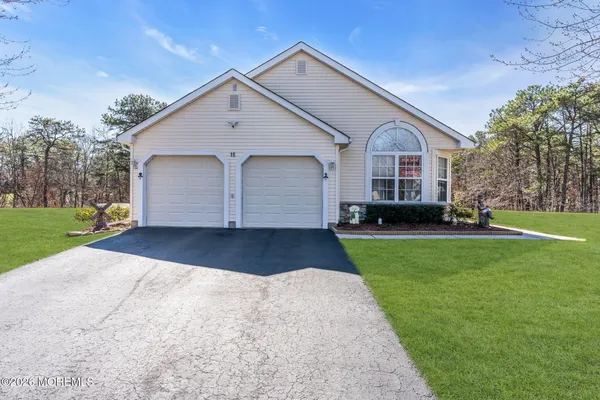 a front view of house with yard and green space