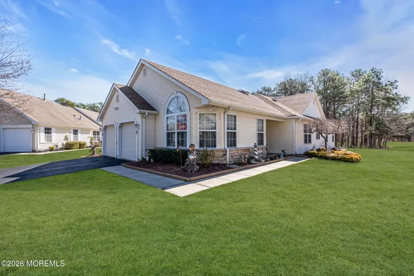 a front view of house with yard and green space