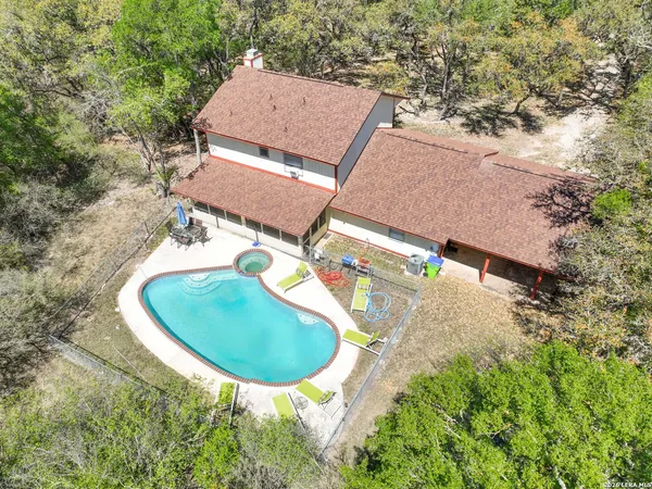 an aerial view of a house with a swimming pool