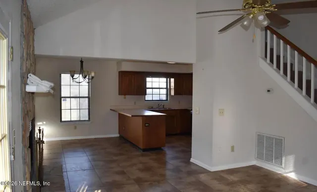 an empty room with windows and cabinet