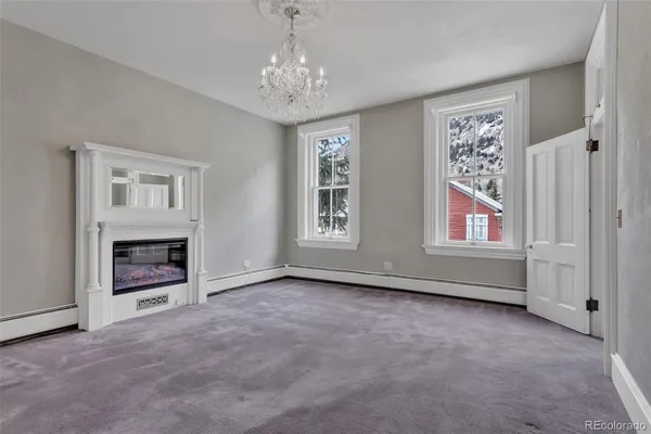 a view of livingroom with furniture fireplace and window