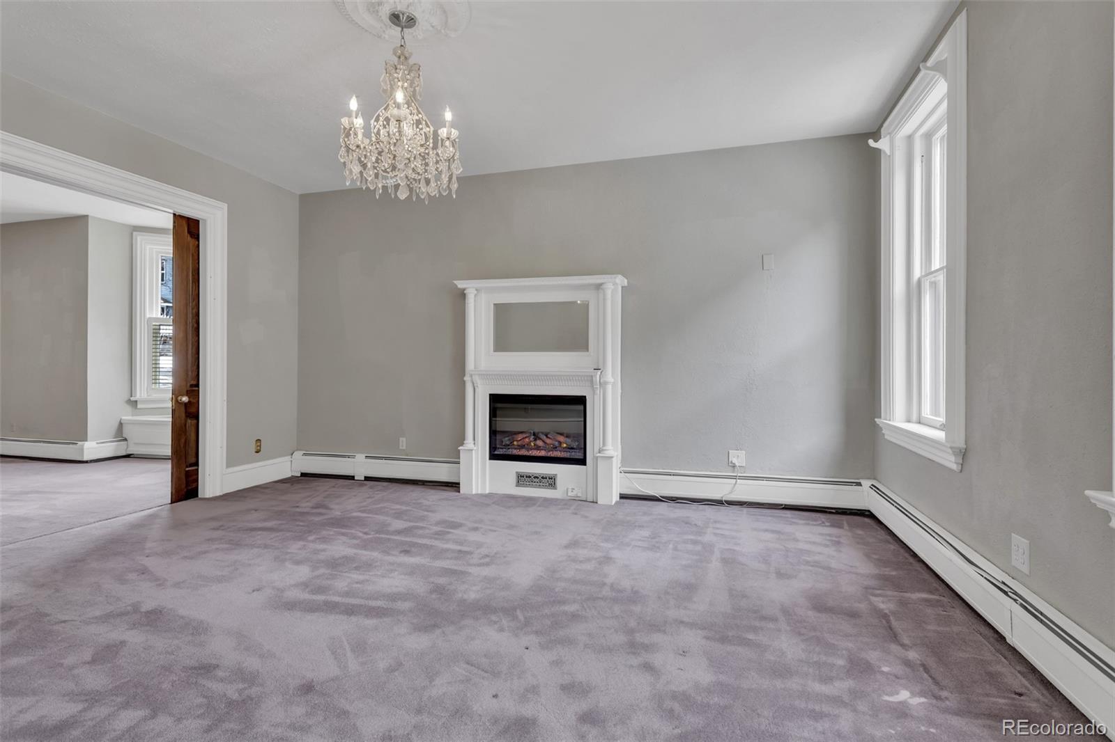 300 Rose Street Georgetown, CO 80444 - Photo 14 of 49 a view of an empty room with a window and fireplace