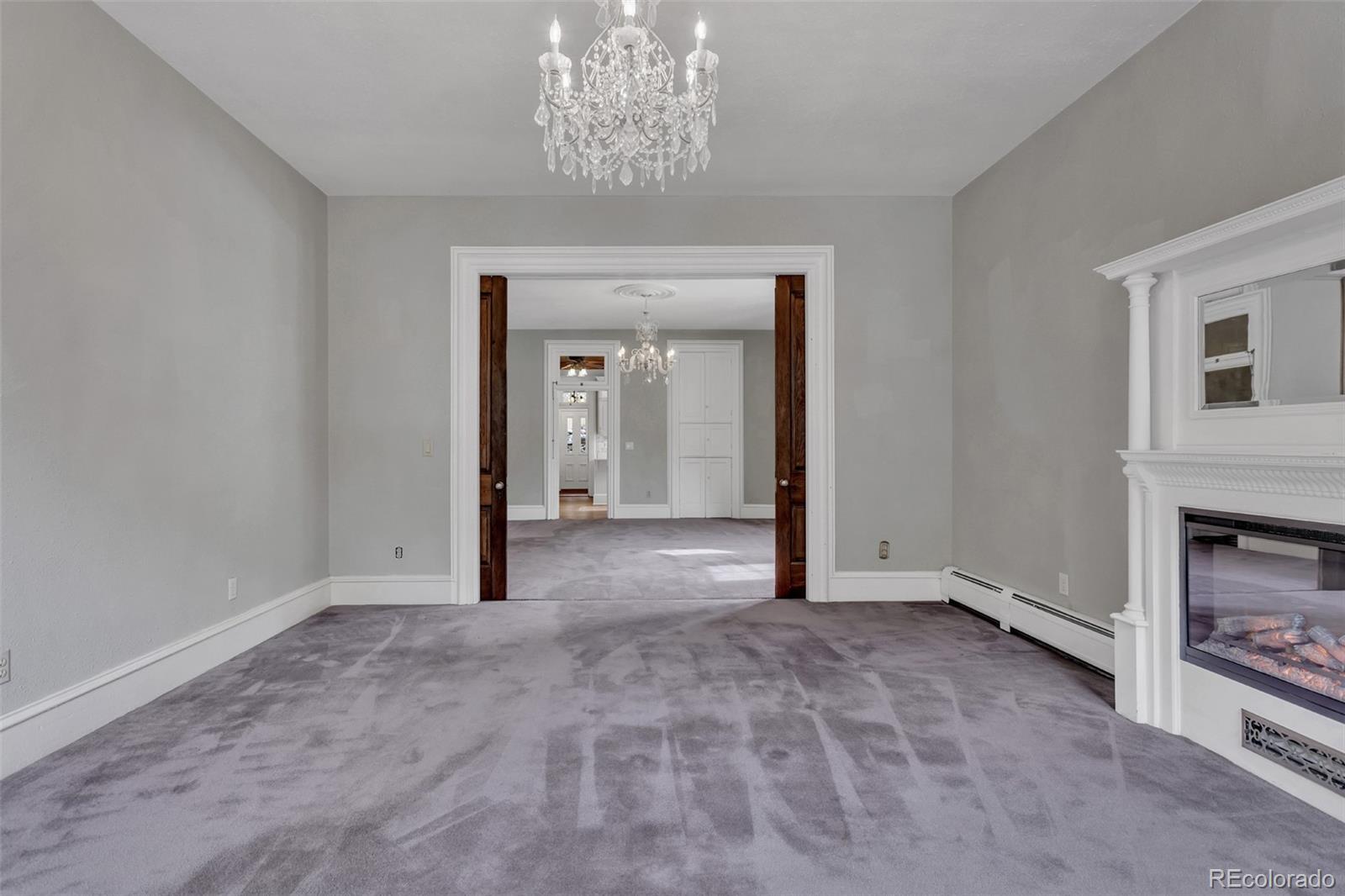 300 Rose Street Georgetown, CO 80444 - Photo 15 of 49 a view of a livingroom with a fireplace a chandelier and windows