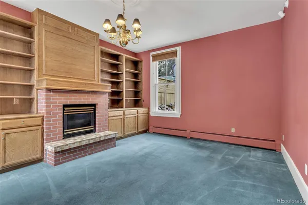 a view of a livingroom with a fireplace and a window