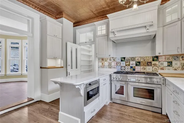 a kitchen with stainless steel appliances granite countertop a stove and a sink