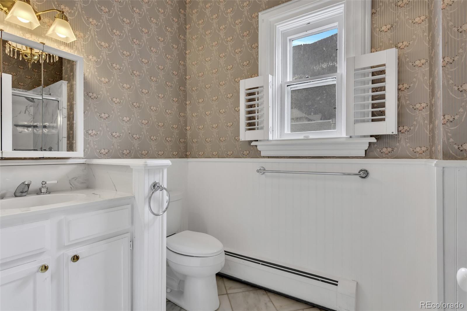 300 Rose Street Georgetown, CO 80444 - Photo 32 of 49 a bathroom with a sink a toilet and a mirror