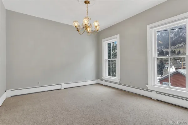 an empty room with a empty space and windows