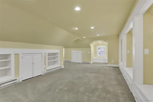 a view of an empty room with a kitchen