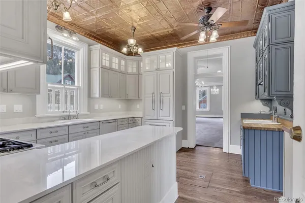 a large kitchen with a sink and cabinets
