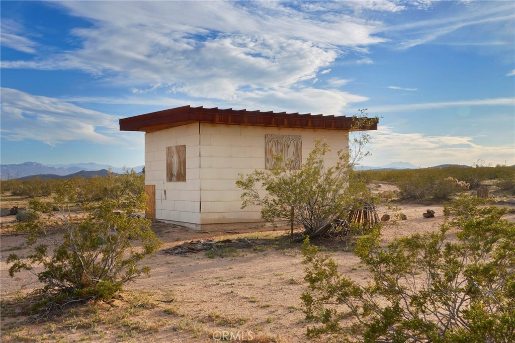 77 Copper Moon Lane Joshua Tree, CA 92252 - Photo 1 of 24 a view of a house with a yard