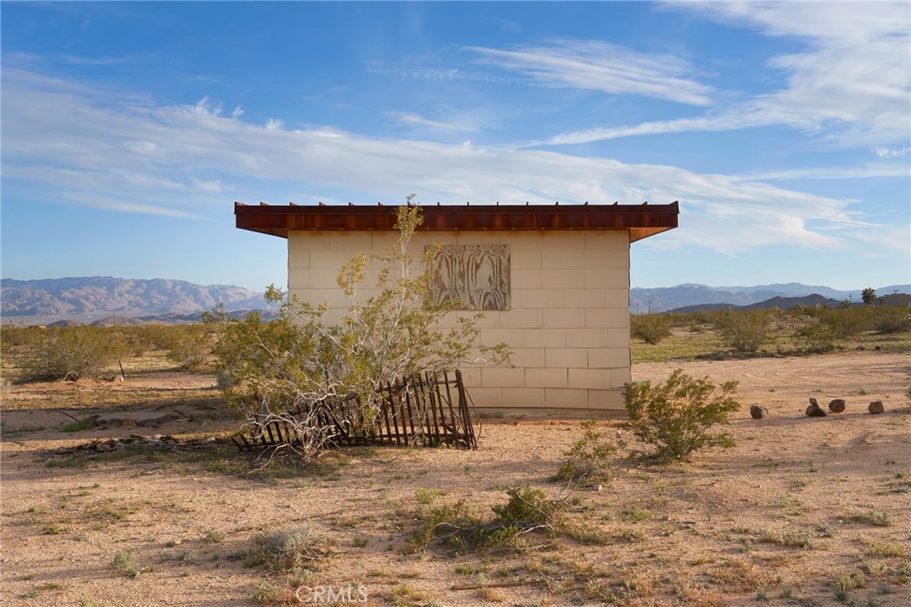 77 Copper Moon Lane Joshua Tree, CA 92252 - Photo 2 of 24 a view of a terrace with a lake view