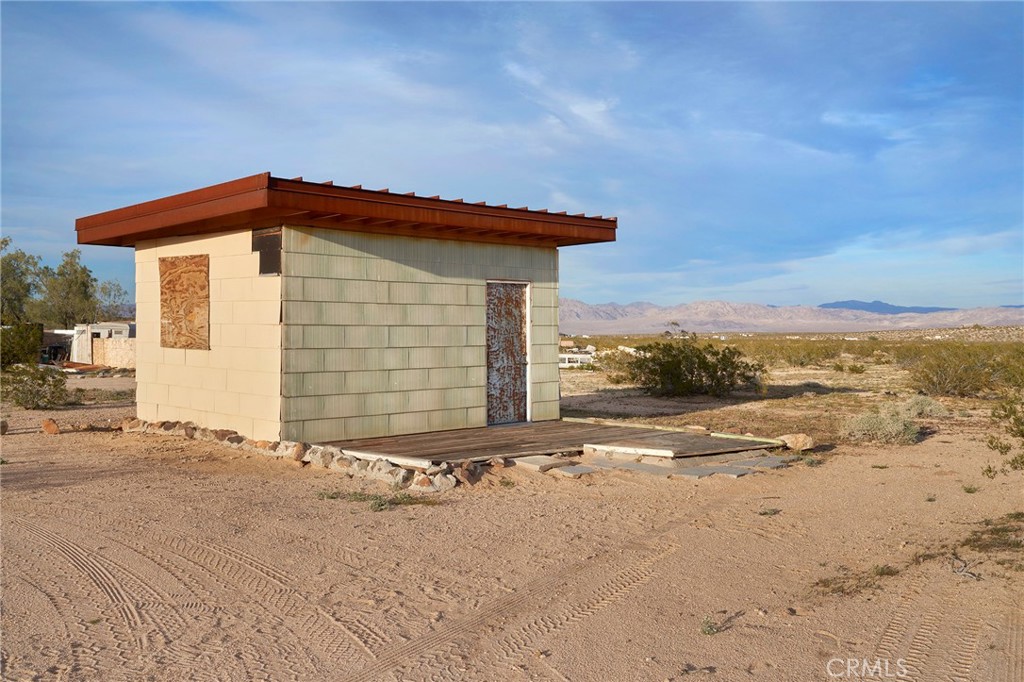 77 Copper Moon Lane Joshua Tree, CA 92252 - Photo 3 of 24 a view of a house with a yard