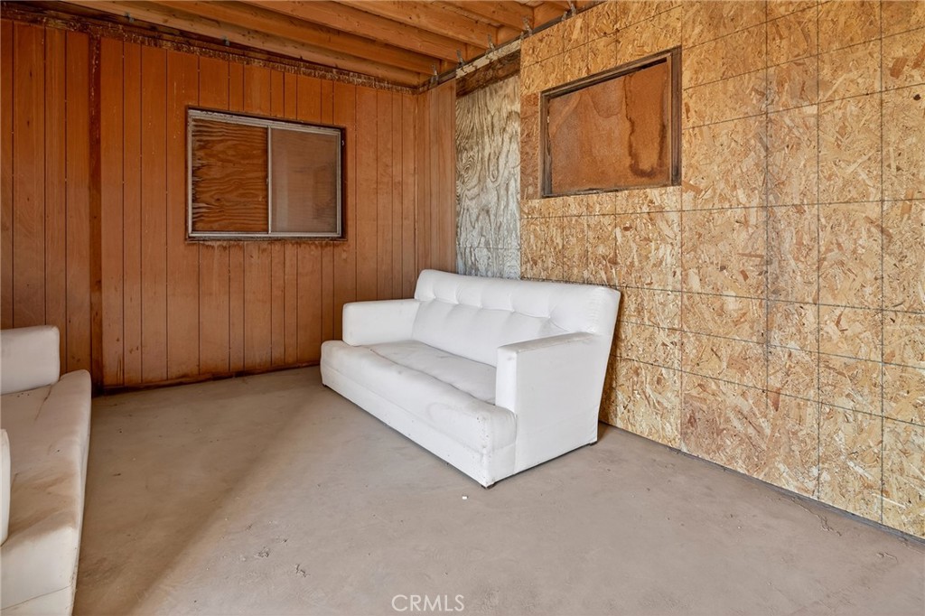 77 Copper Moon Lane Joshua Tree, CA 92252 - Photo 5 of 24 a view of an empty room with a brick wall