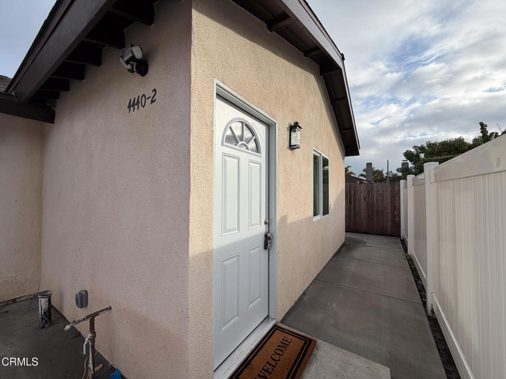 a view of a house with backyard and wooden floor