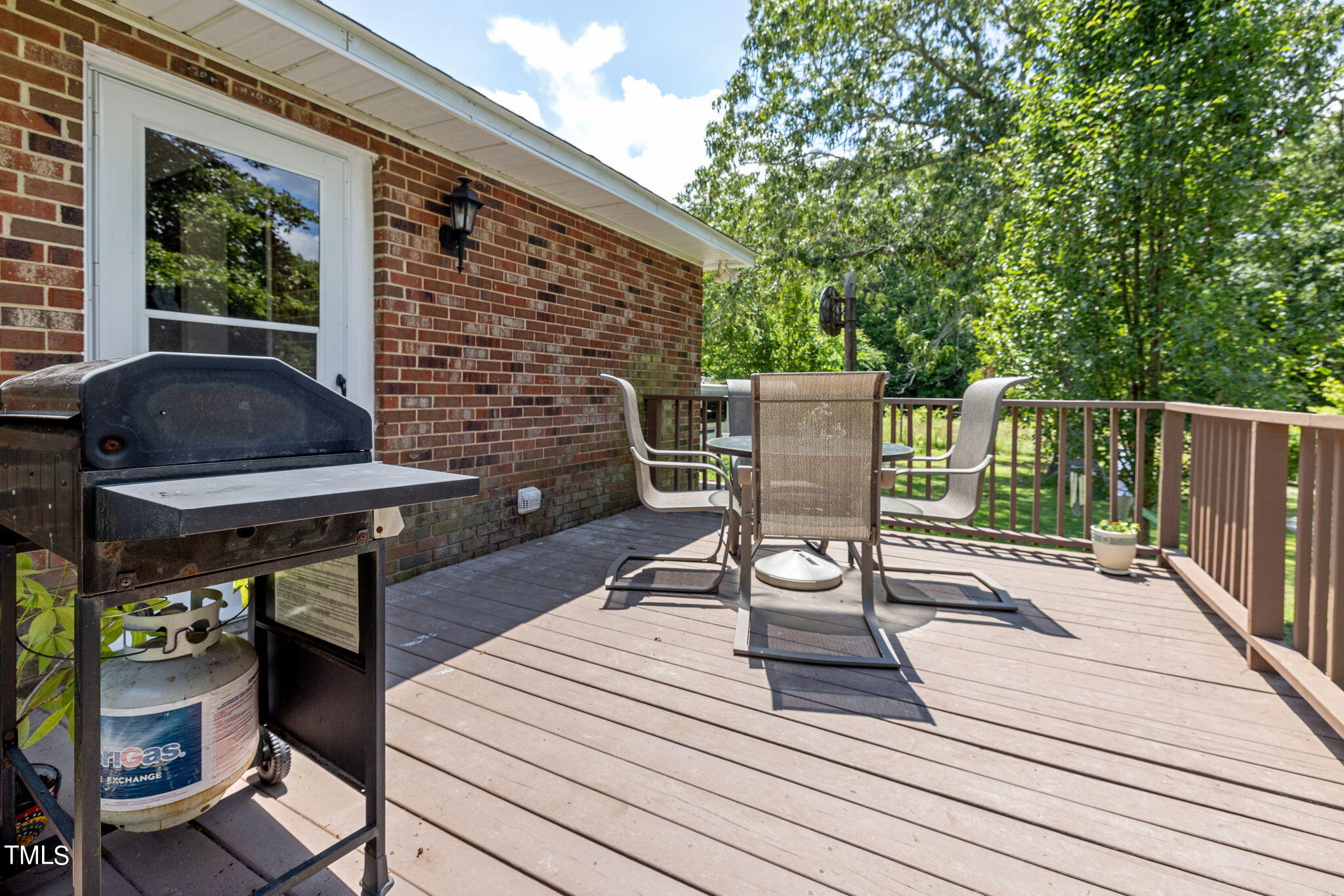 212 Hawkins Road Cedar Grove, NC 27231 - Photo 19 of 36 a view of a deck with chair and table