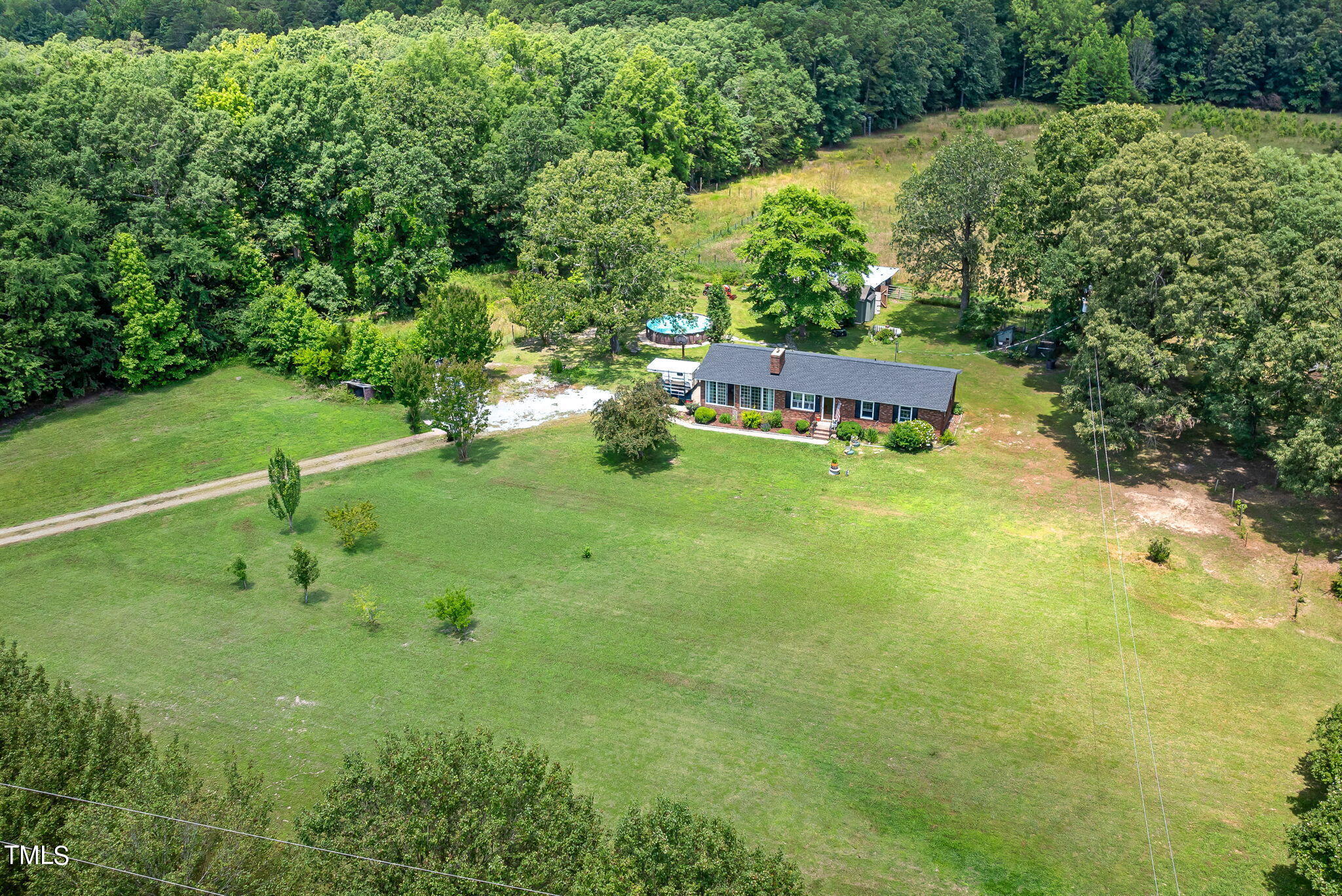 212 Hawkins Road Cedar Grove, NC 27231 - Photo 30 of 36 a backyard of a house with lots of green space and plants