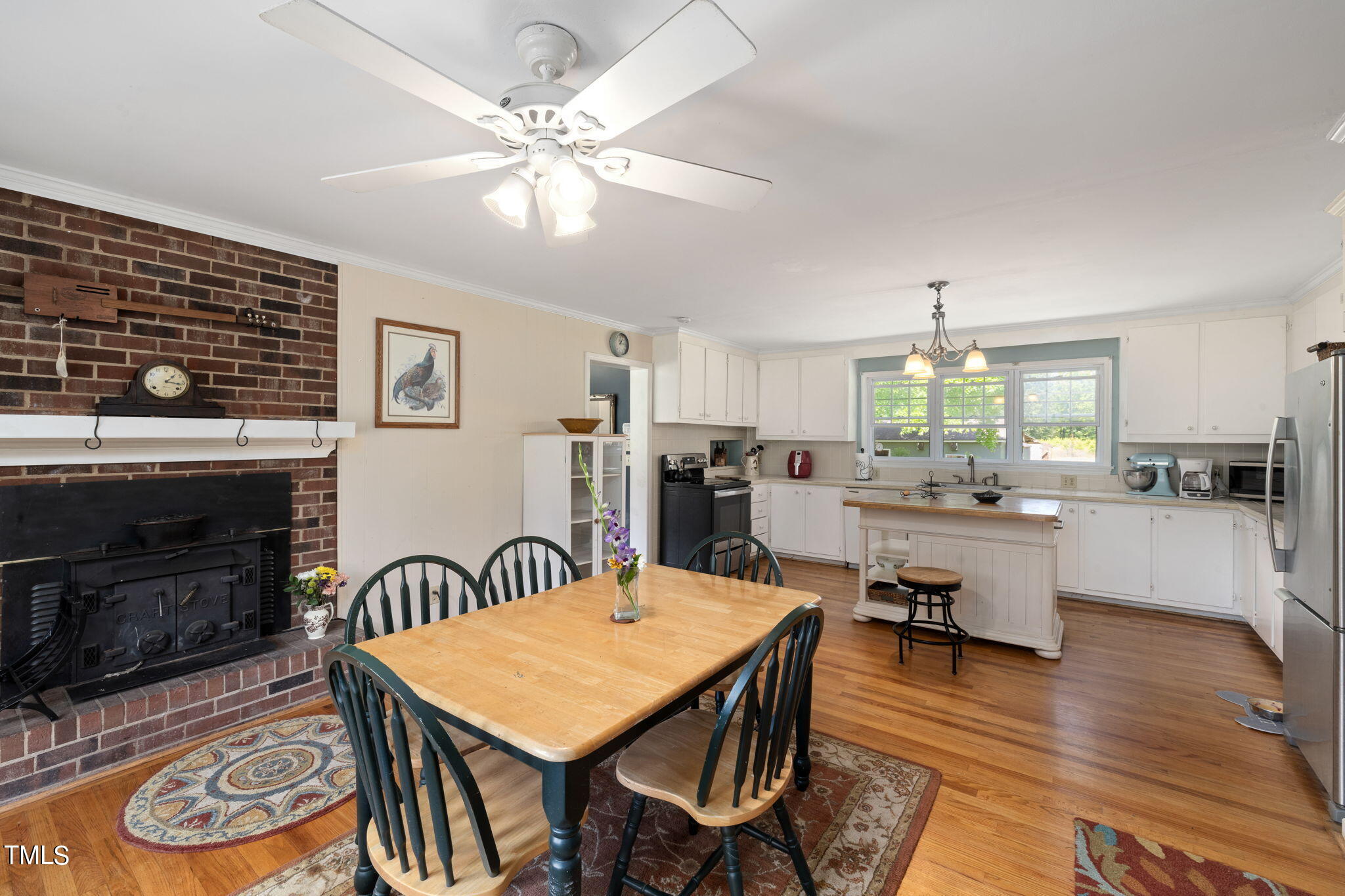 212 Hawkins Road Cedar Grove, NC 27231 - Photo 4 of 36 a open dining room with stainless steel appliances kitchen island granite countertop furniture and fireplace