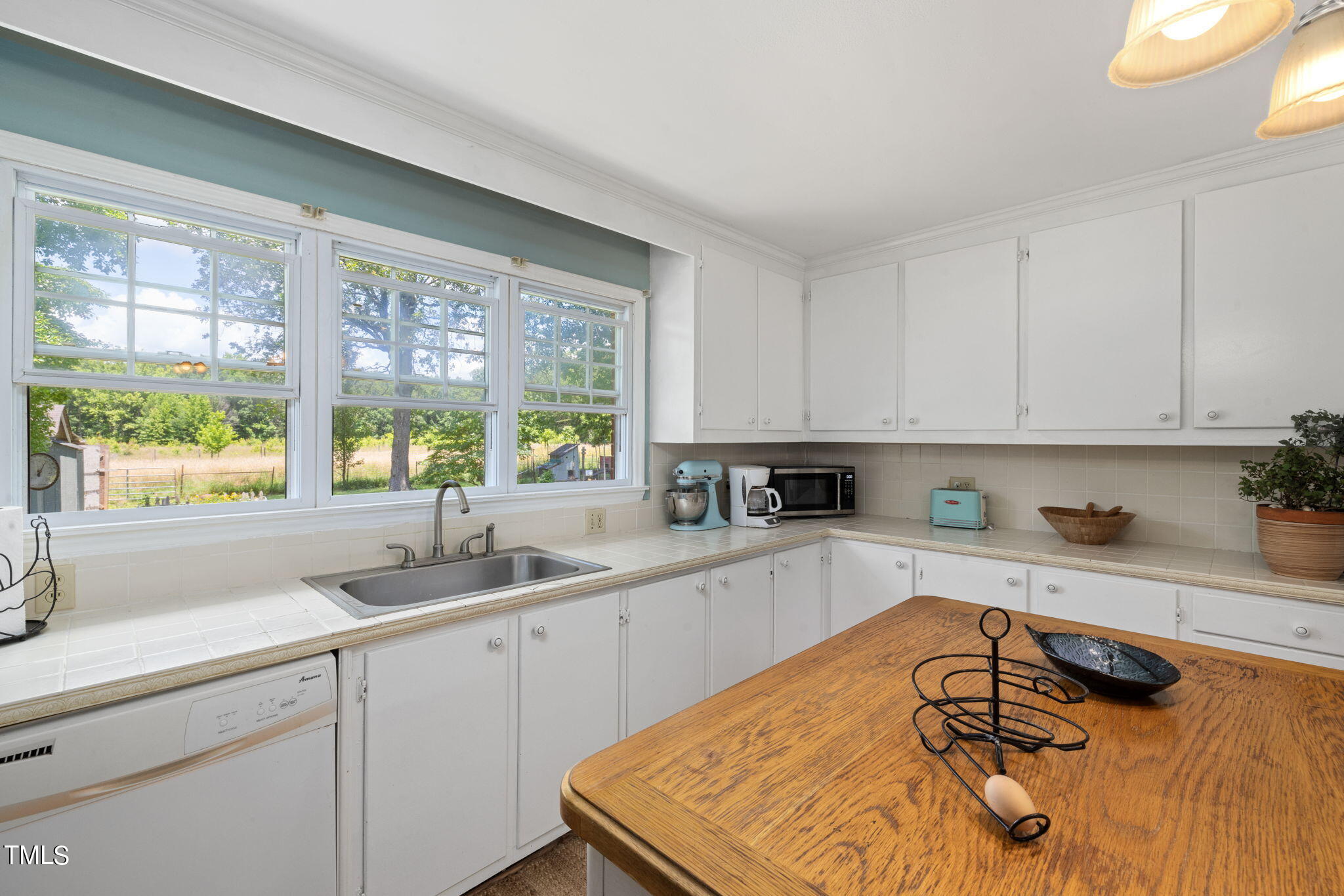212 Hawkins Road Cedar Grove, NC 27231 - Photo 8 of 36 a kitchen with a sink a window and cabinets
