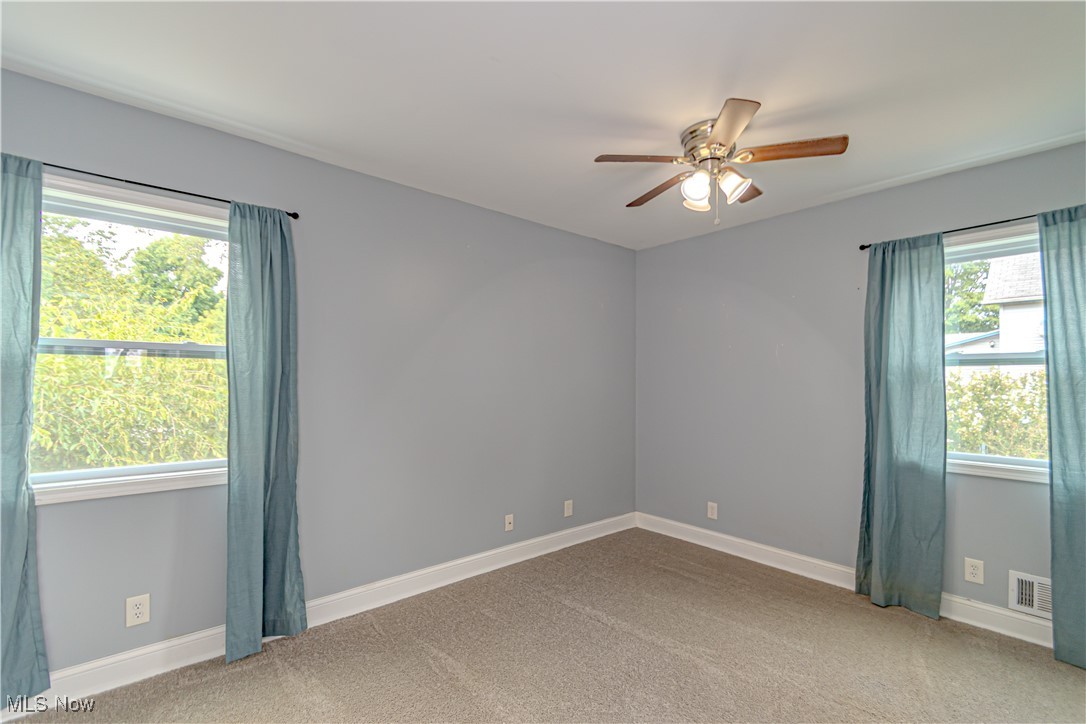 360 Baldwin Road Akron, OH 44312 - Photo 12 of 22 Unfurnished room with carpet and a ceiling fan