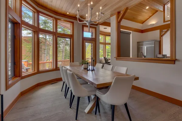 a view of a dining room with furniture large windows and wooden floor