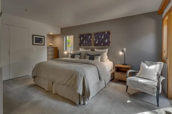 a bedroom with a bed and lamp