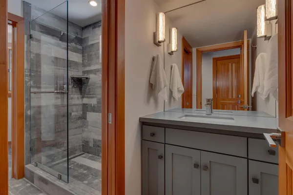 a bathroom with a shower and a sink