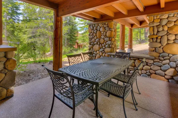 a view of an outdoor dining space with a table and chairs