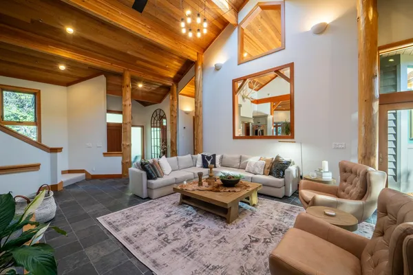 a living room with furniture a rug and a chandelier