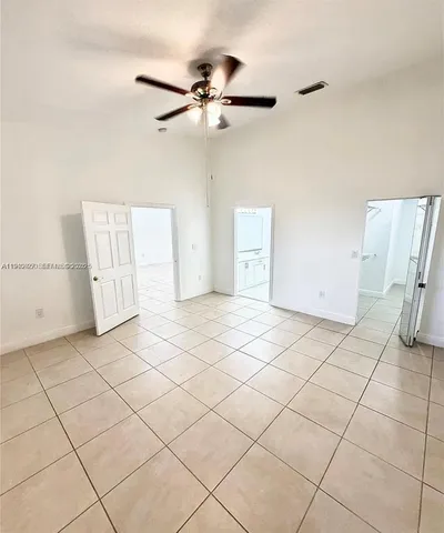 a view of a livingroom with white cabinets and wooden floor