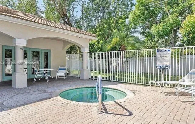 a view of a chair and tables in the patio
