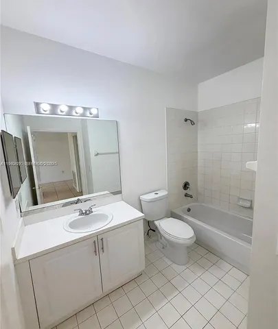 a bathroom with a double vanity sink mirror and toilet