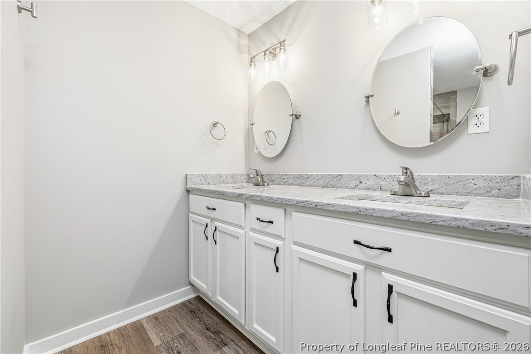 3524 Pine Log Road Lumberton, NC 28360 - Photo 31 of 42 a bathroom with a granite countertop double vanity and mirror