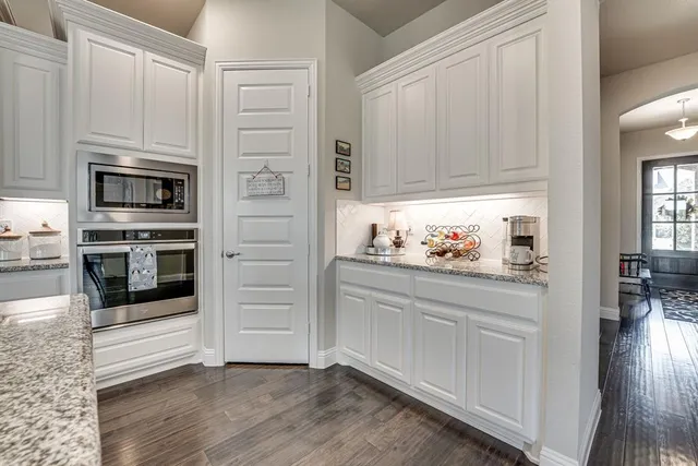 a kitchen with stainless steel appliances a refrigerator a stove top oven and a center island