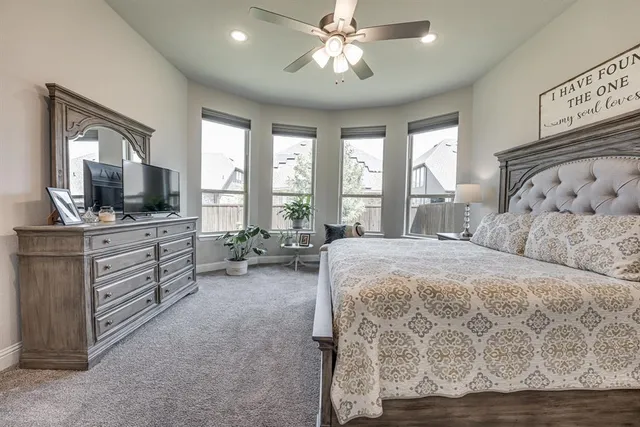 a dining room with wooden floor a chandelier a wooden table and chairs