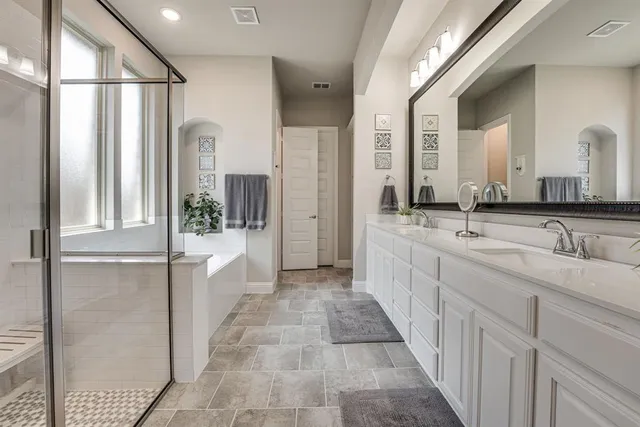 a bathroom with double sink and a mirror