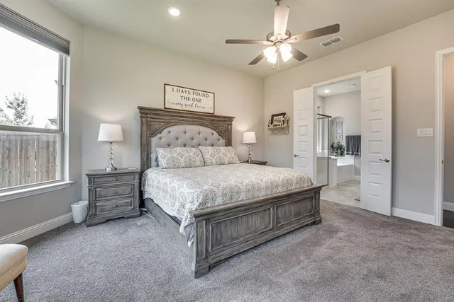 a bathroom with a shower sink vanity mirror and toilet