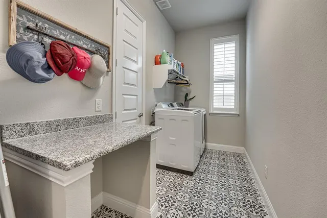 a bedroom with a bed couch and windows