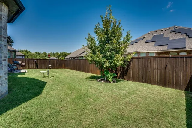 a spacious bedroom with a bed a chandelier and a large window